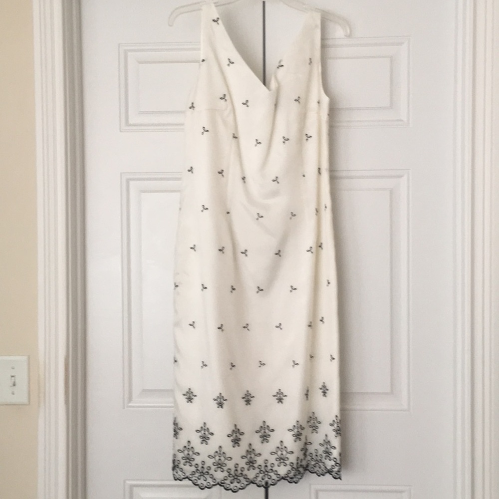 White satiny sheath with embroidered overlay